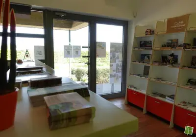 a room with a store with a large glass door at Camping Houtum in Kasterlee