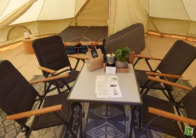 a table and chairs in front of a tent at Camping Houtum in Kasterlee