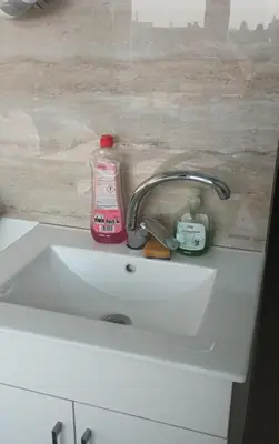 a sink with a bottle of detergent and a soap at Private Studio Brussels Airport in Brussels