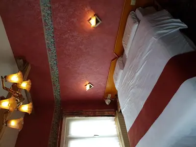 a bedroom with a large bed and a window at Hotel La Barakka in Lokeren