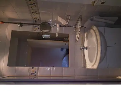 a bathroom with a toilet and a mirror at Hotel La Barakka in Lokeren