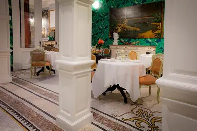 a dining room with a white table and chairs at Cabosse, Boutique Palace & Spa in Antwerp