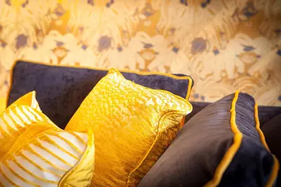 two yellow pillows sitting on top of a couch at Cabosse, Boutique Palace & Spa in Antwerp