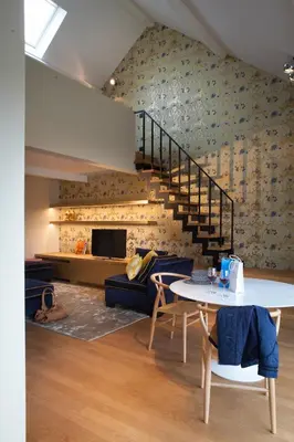 a living room with a staircase and a table at Cabosse, Boutique Palace & Spa in Antwerp