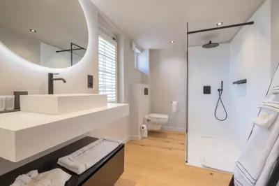 a bathroom with a white sink and a shower at B&B Sterckxhof in Meise