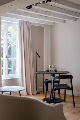 a table and chairs in a room with a window at B&B Sterckxhof in Meise