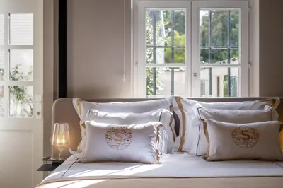 a white bed with white pillows and a window at B&B Sterckxhof in Meise