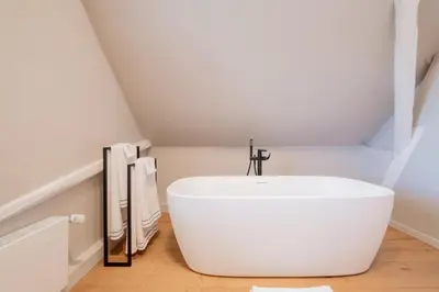 a bathroom with a white tub in a room at B&B Sterckxhof in Meise