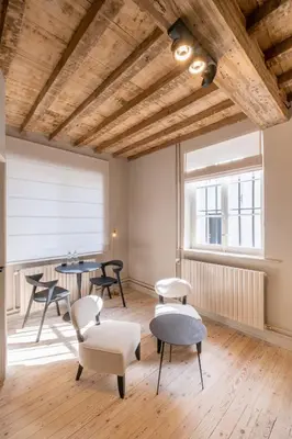 a room with chairs and tables and a window at B&B Sterckxhof in Meise