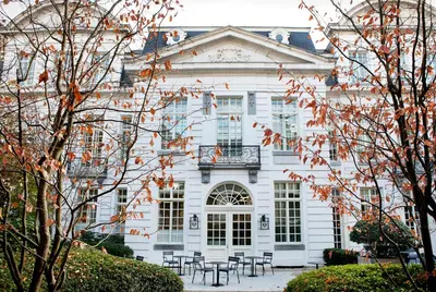 a white house with tables and chairs in front of it at Pillows Grand Boutique Hotel Reylof Ghent in Ghent