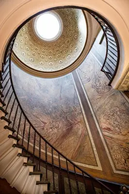 a spiral staircase with a painting on the ceiling at Pillows Grand Boutique Hotel Reylof Ghent in Ghent