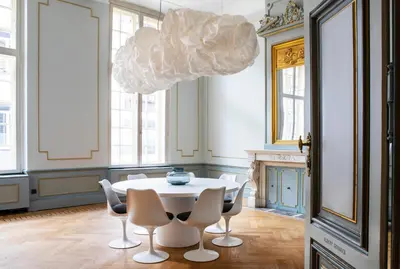 a dining room with a table and chairs and a chandelier at Pillows Grand Boutique Hotel Reylof Ghent in Ghent