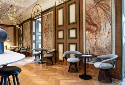 a row of tables and chairs in a room with a painting at Pillows Grand Boutique Hotel Reylof Ghent in Ghent