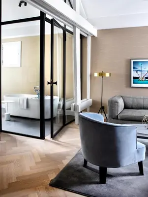 a living room with a tub and a couch at Pillows Grand Boutique Hotel Reylof Ghent in Ghent