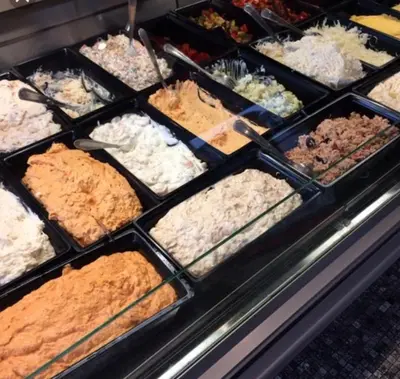 a display case filled with different types of food at Private Studio Brussels Airport in Brussels
