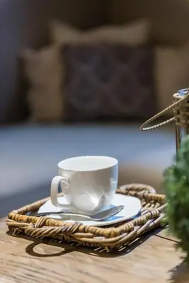 a white coffee cup and saucer on a table at Casa-Cosi, tourist & business suites & flats with reserved parking included, private sauna in Lokeren