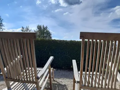 two wooden chairs sitting next to each other at Casa-Cosi, tourist & business suites & flats with reserved parking included, private sauna in Lokeren
