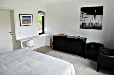 a bedroom with a bed and a desk and a chair at Nena Guesthouse in Leuven