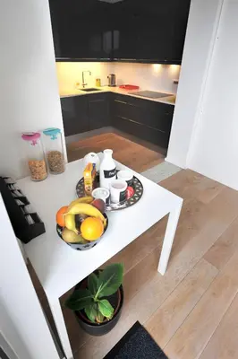 a white table with fruit on it in a kitchen at B&B Kava in Antwerp