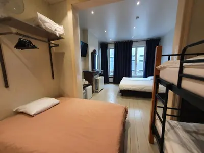 a room with two bunk beds and a television at Albert - Rooms in Mechelen