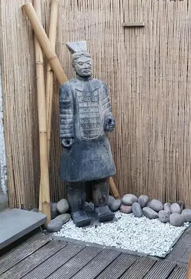 a statue of a samurai standing in front of a fence at Albert - Rooms in Mechelen