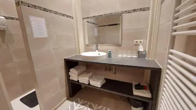 a bathroom with a sink and a mirror at Albert - Rooms in Mechelen