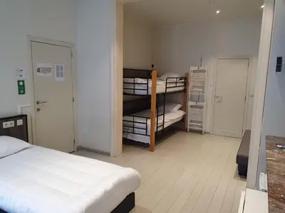 a room with a bed and a room with bunk beds at Albert - Rooms in Mechelen