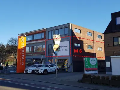 a building with two cars parked in front of it at Mathilda - apartments in Grobbendonk