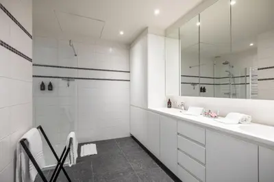 a white bathroom with a sink and a mirror at Logement Den Beer in Meerhout