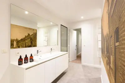 a bathroom with two sinks and a mirror at Logement Den Beer in Meerhout