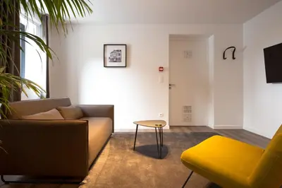 a living room with a couch and a table at Logement Den Beer in Meerhout