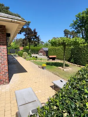 a patio with two benches and a picnic table at villa 2be in Balen