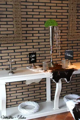 a white table with a vase on top of it at villa 2be in Balen