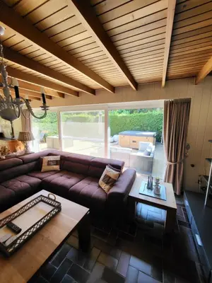 a living room with a couch and a table at villa 2be in Balen