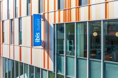 a building with a sign on the side of it at ibis budget Leuven Centrum in Leuven