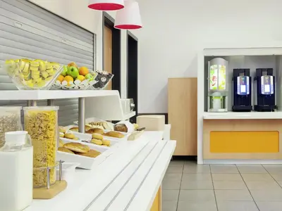 a bakery with many different types of food on a counter at ibis budget Antwerpen Centraal Station in Antwerp