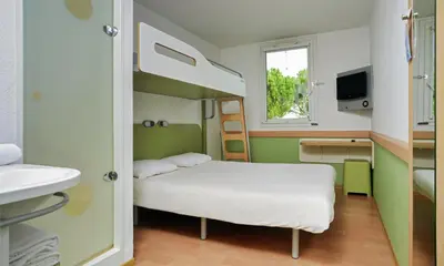 a small room with a bunk bed and a sink at ibis budget Antwerpen Centraal Station in Antwerp