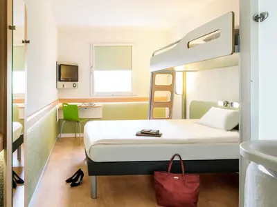 a hotel room with a bed and a sink at ibis budget Antwerpen Port in Antwerp