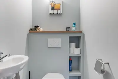 a white bathroom with a sink and a toilet at Van Hamme 1642 - house for 2 to 4 persons in Kortenberg