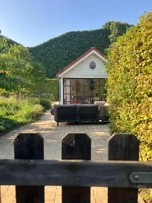 a couch sitting in front of a house at Van Hamme 1642 - house for 2 to 4 persons in Kortenberg