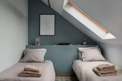 two beds with towels on them in a bedroom at Van Hamme 1642 - house for 2 to 4 persons in Kortenberg