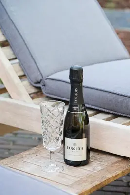 a bottle of wine and a glass on a table at B&B De Hanewijkhoeve in Werchter