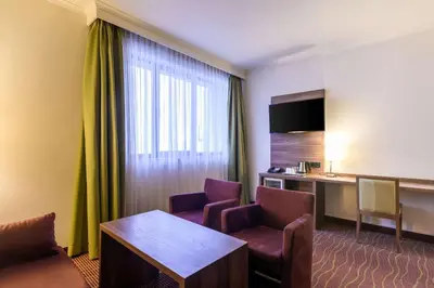 a hotel room with a table and two chairs at Hotel Opera Antwerpen Centrum in Antwerp