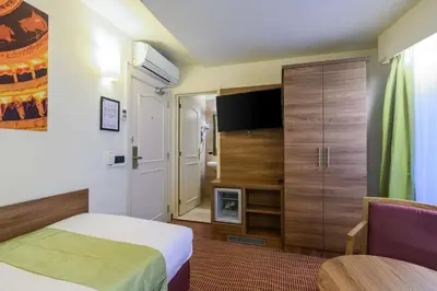 a hotel room with a bed and a tv at Hotel Opera Antwerpen Centrum in Antwerp
