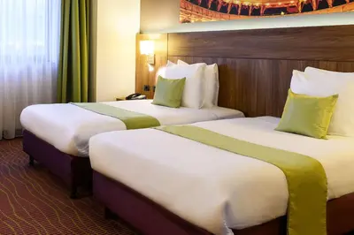 two beds in a hotel room with two at Hotel Opera Antwerpen Centrum in Antwerp