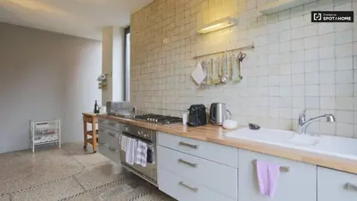 a kitchen with a sink and a counter top at Rez/duplex 3 ch et jardin in Brussels