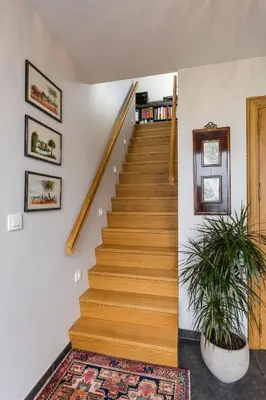 a staircase in a home with a potted plant at Polderwoning 'Cleylantshof' in Sint-Laureins