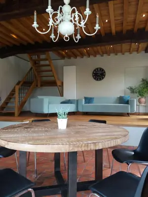 a living room with a table and a couch at Logies Berckelaer in Sint-Gillis-Waas