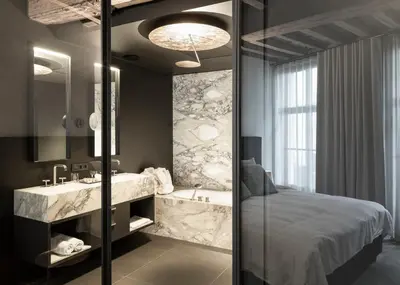 a bathroom with a bed and a sink and a tub at Gulde Schoen Luxury Studio-apartments in Antwerp