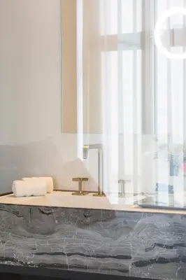 a bathroom with a sink and a mirror at Gulde Schoen Luxury Studio-apartments in Antwerp